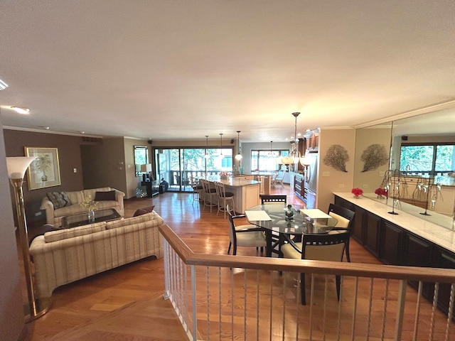 dining area with crown molding and a chandelier