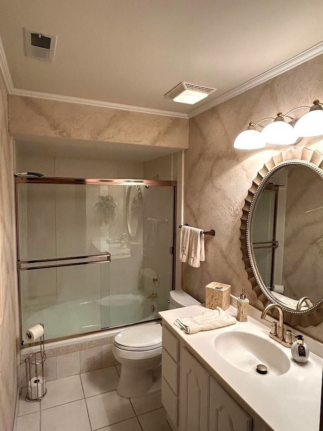 full bathroom with vanity, bath / shower combo with glass door, tile patterned floors, ornamental molding, and toilet