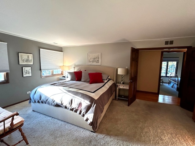 carpeted bedroom featuring ornamental molding