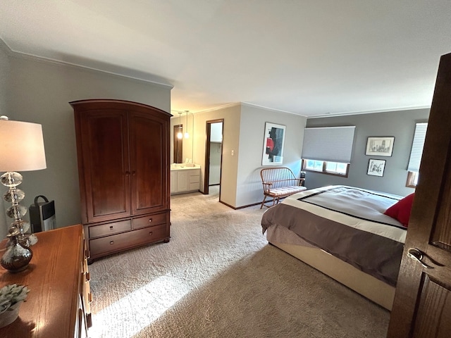 carpeted bedroom featuring crown molding and connected bathroom