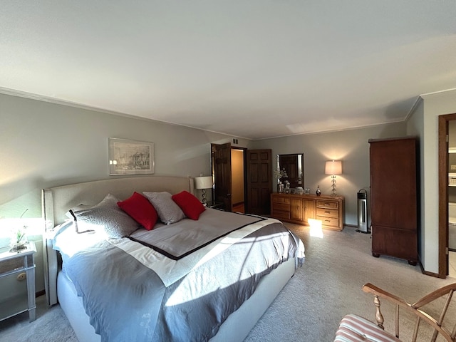 bedroom with crown molding and light carpet