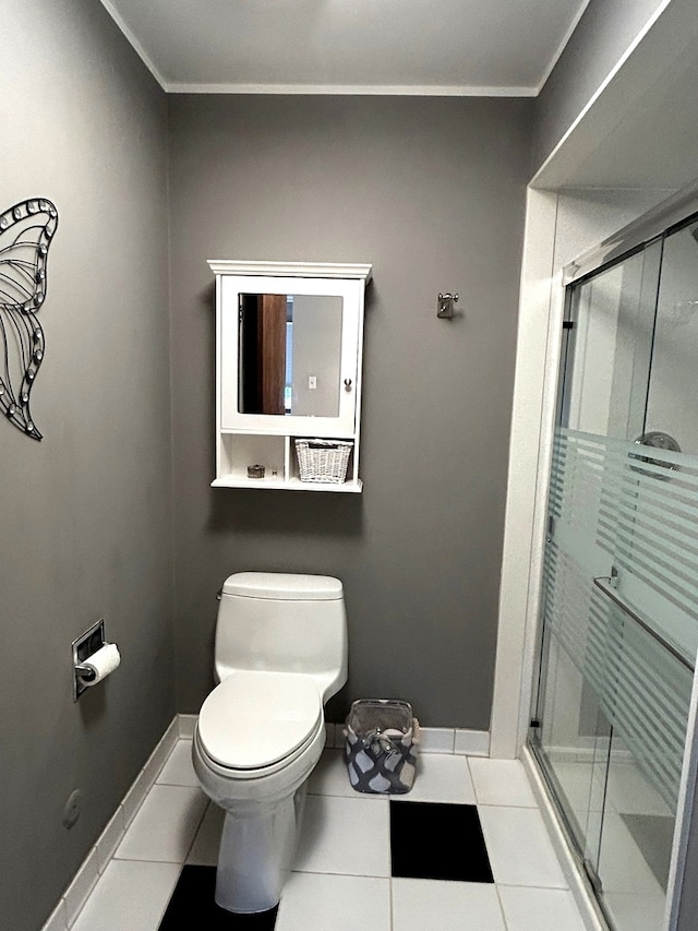 bathroom featuring tile patterned flooring, an enclosed shower, ornamental molding, and toilet