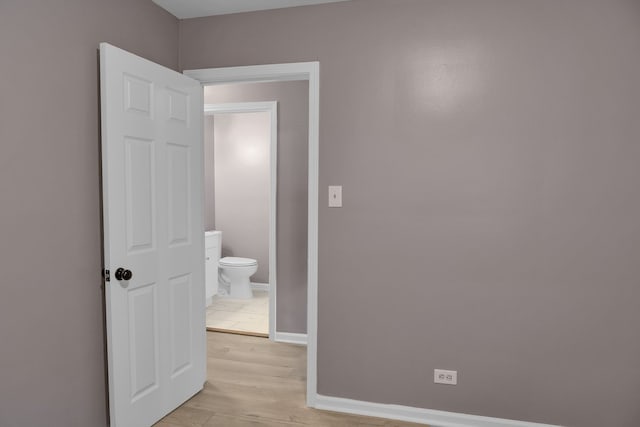 interior space featuring light wood-type flooring and ensuite bathroom