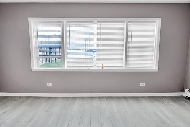 spare room featuring light hardwood / wood-style floors