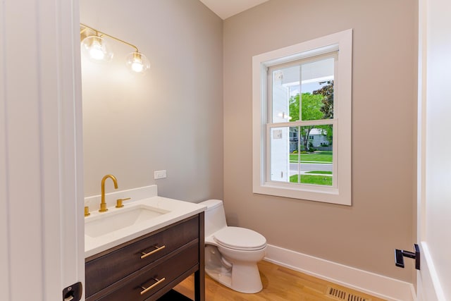 bathroom featuring hardwood / wood-style flooring, vanity, and toilet