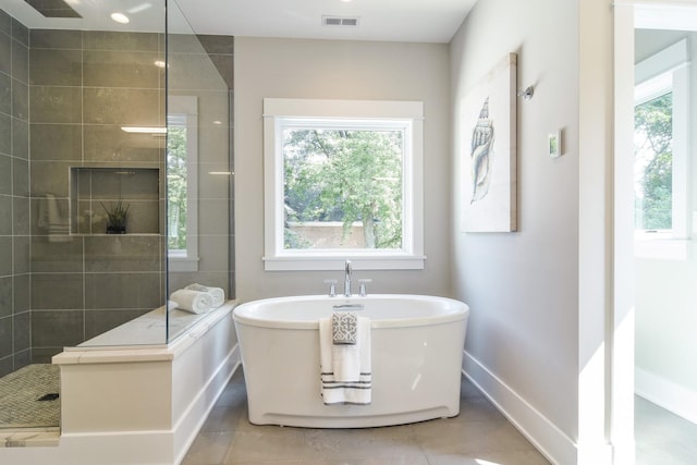 bathroom with tile patterned flooring and separate shower and tub