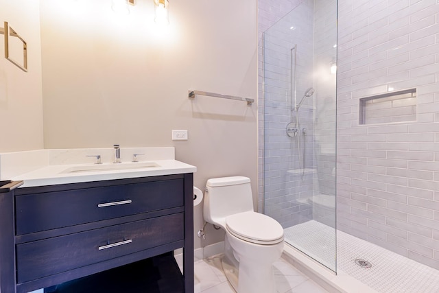 bathroom with tiled shower, vanity, and toilet