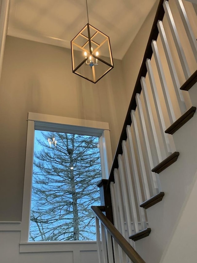 staircase with a chandelier