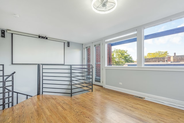 empty room with hardwood / wood-style flooring