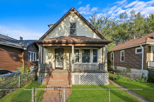 bungalow-style house with covered porch and a front yard