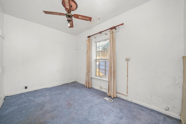 empty room with ceiling fan and carpet flooring