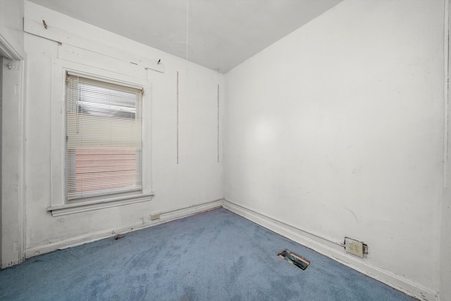 carpeted spare room with vaulted ceiling