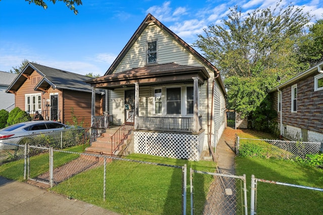 bungalow-style home with a front yard and covered porch