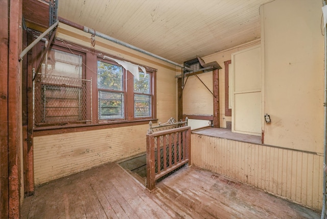 misc room featuring wooden walls and hardwood / wood-style flooring