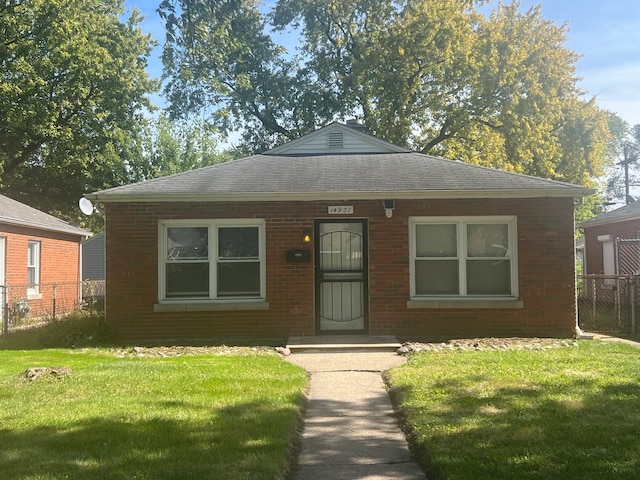 bungalow-style home featuring a front yard