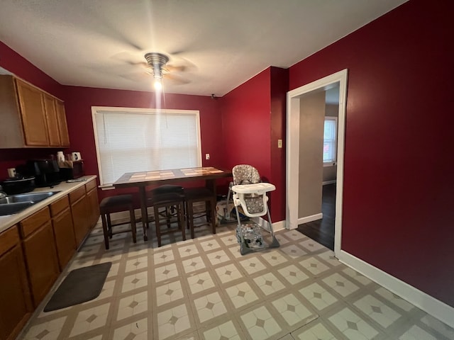 dining room with ceiling fan and sink