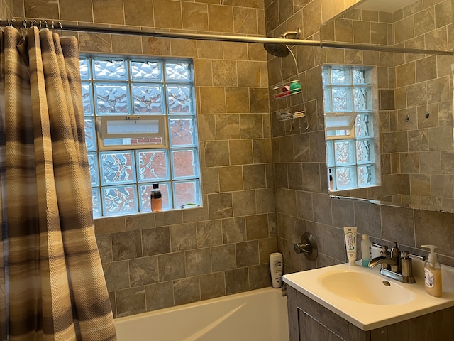 bathroom featuring tasteful backsplash, shower / bathtub combination with curtain, vanity, and a wealth of natural light