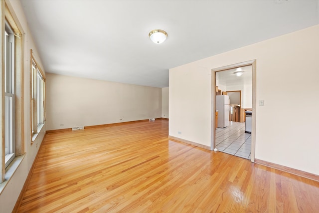 spare room with light wood-type flooring