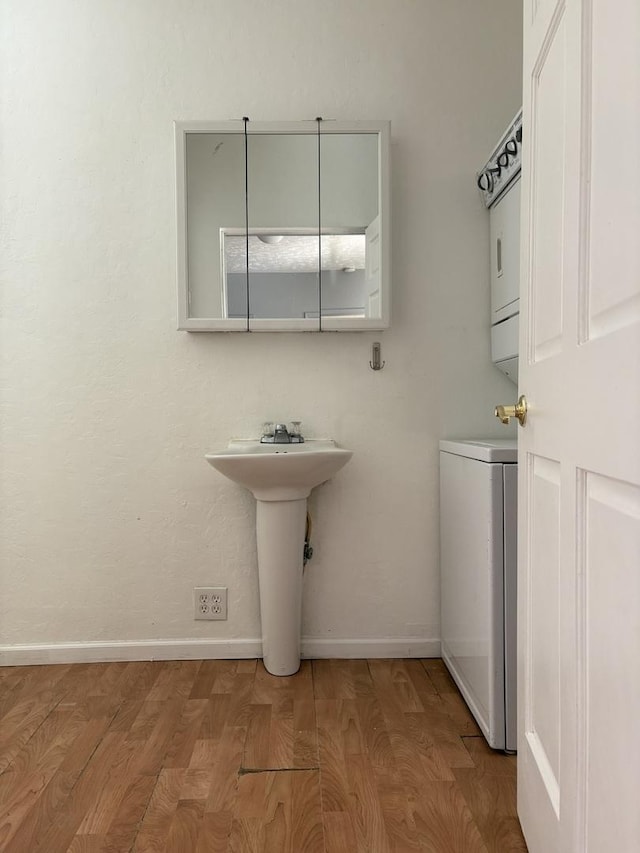 bathroom featuring wood finished floors, a sink, and baseboards