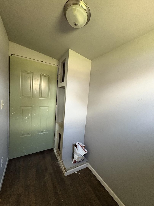 interior space with baseboards and wood finished floors