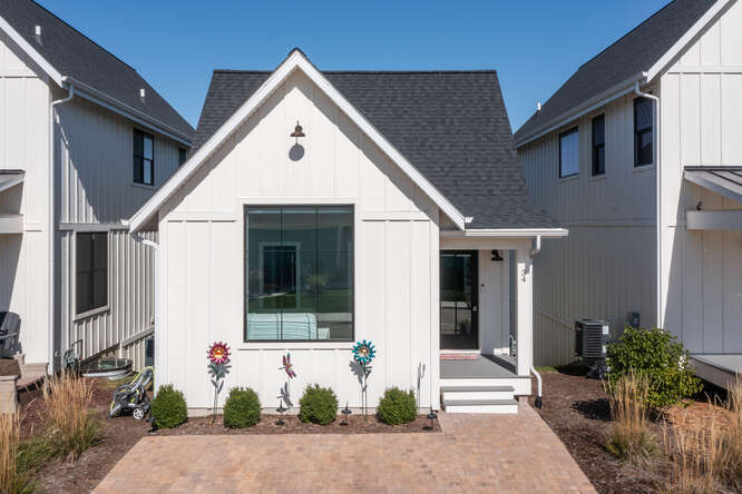 modern farmhouse style home featuring central AC unit