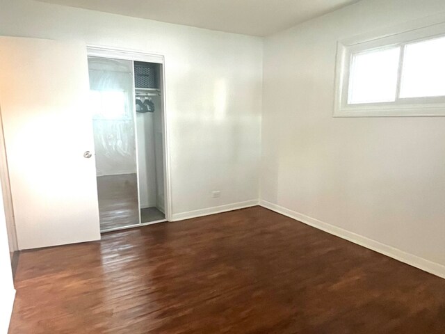 3140 Sherwood Ave, Markham, IL 60428 - unfurnished bedroom with a closet and dark wood-style flooring
