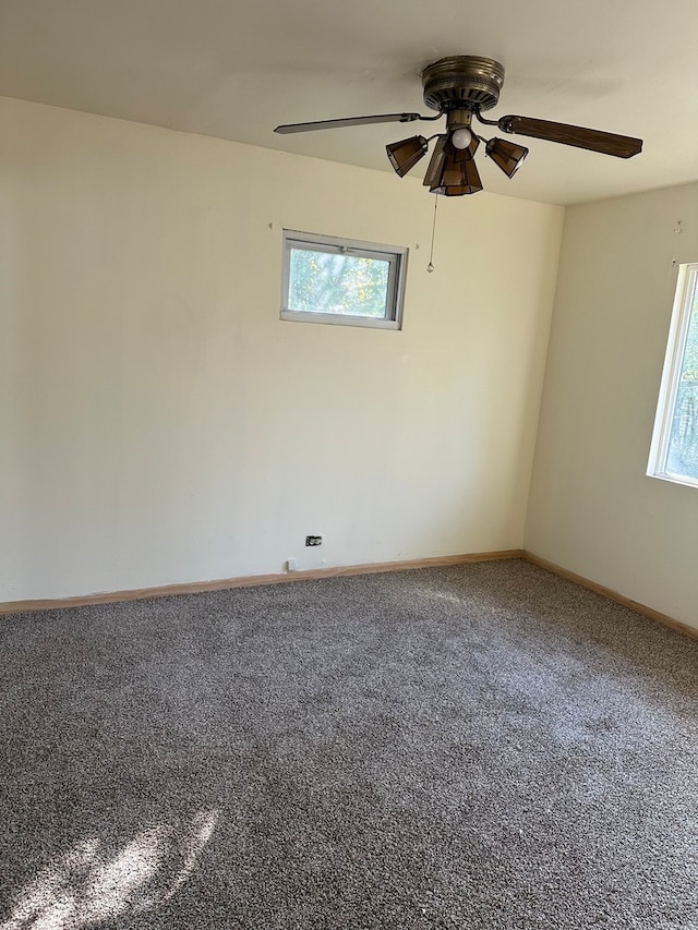 empty room with carpet flooring, plenty of natural light, and ceiling fan