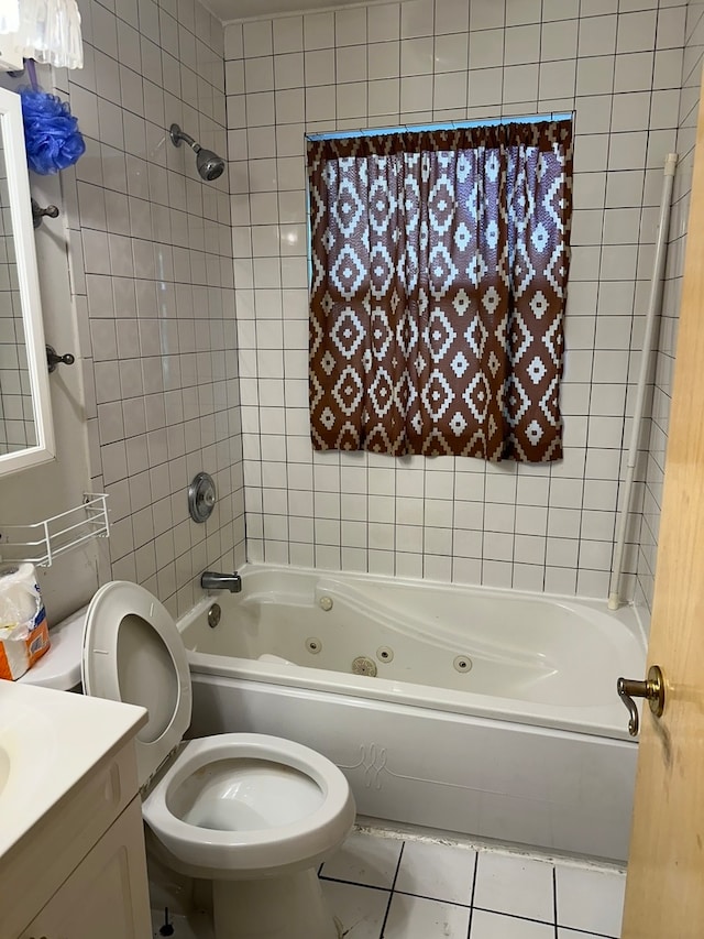 full bathroom with vanity, toilet, tile patterned floors, and tiled shower / bath combo