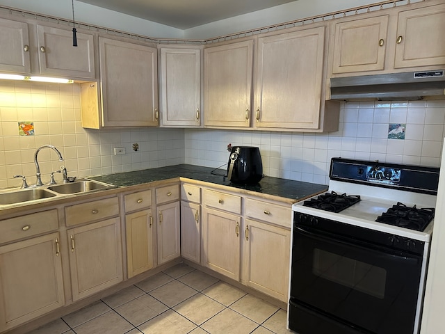 kitchen with decorative backsplash, light brown cabinets, white gas range, sink, and light tile patterned floors