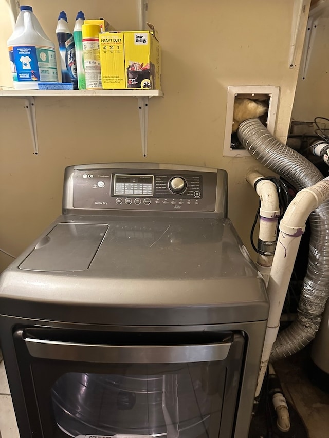 clothes washing area featuring washer / dryer