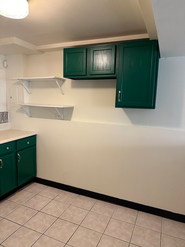 kitchen featuring green cabinetry and light tile patterned floors