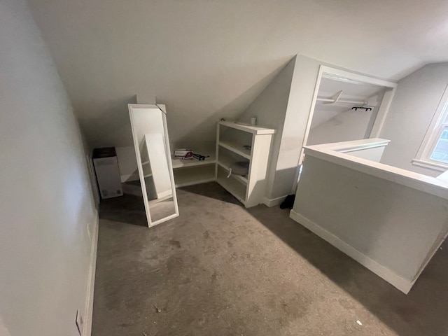 bathroom with concrete flooring and vaulted ceiling