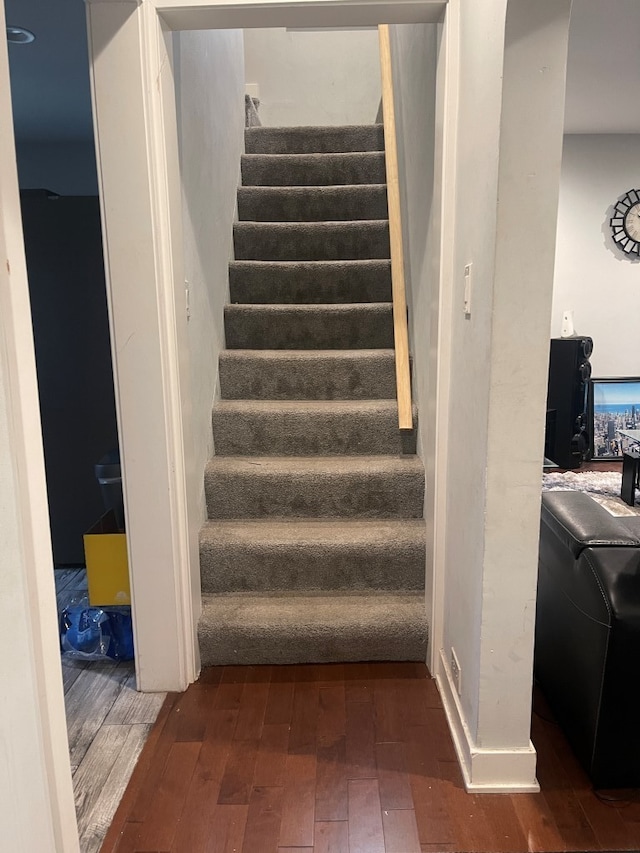 stairs with hardwood / wood-style flooring