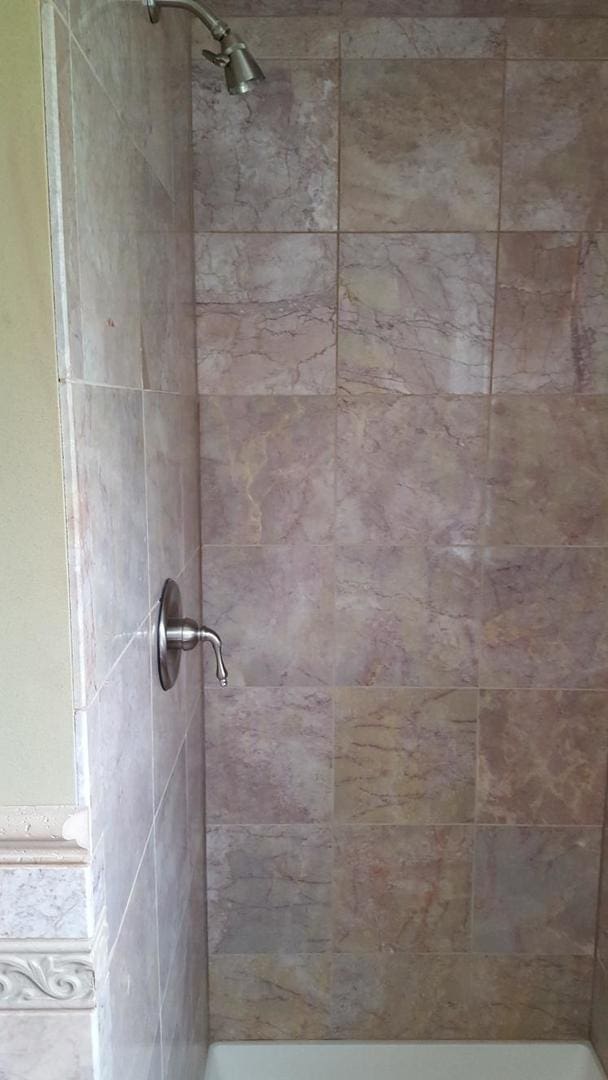 bathroom with tiled shower