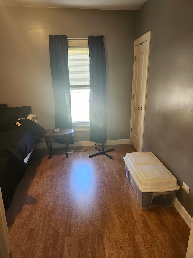 bedroom with hardwood / wood-style flooring