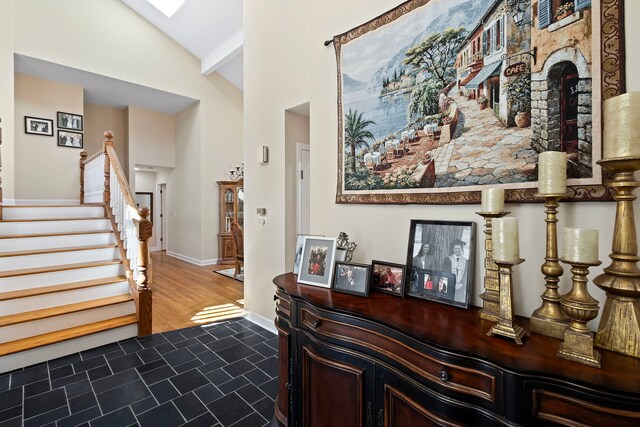 living room with light hardwood / wood-style floors and high vaulted ceiling