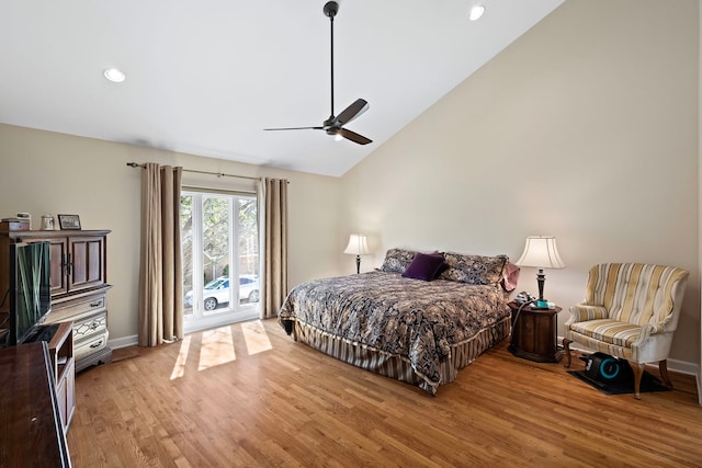 bedroom featuring high vaulted ceiling, light hardwood / wood-style floors, ceiling fan, and access to exterior