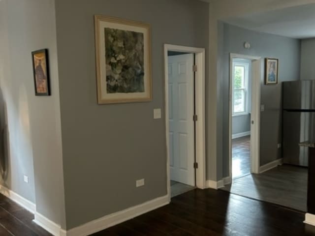 corridor with dark wood-type flooring