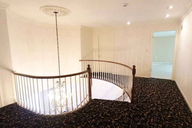 staircase featuring carpet floors, a notable chandelier, and ornamental molding