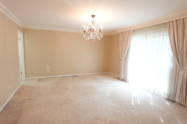 carpeted spare room with an inviting chandelier and ornamental molding