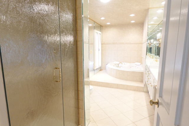 full bathroom with vanity, tile patterned flooring, shower with separate bathtub, tile walls, and toilet