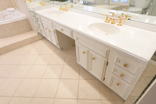 bathroom featuring vanity, tiled bath, toilet, and tile patterned floors