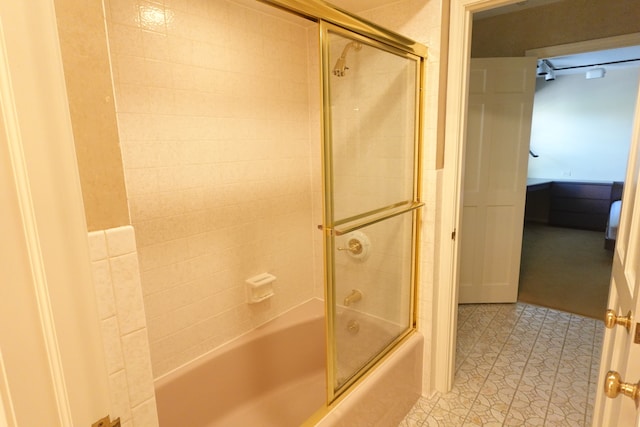 bathroom with shower / bath combination with glass door