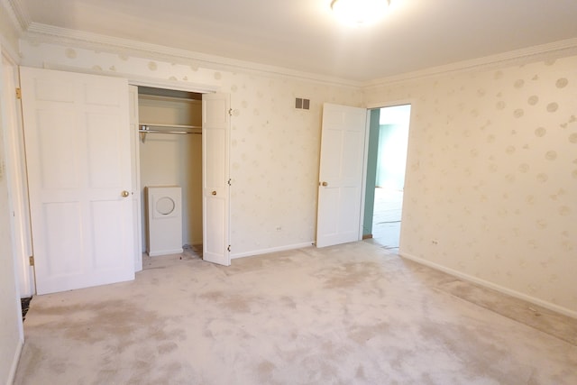 unfurnished bedroom with ornamental molding, a closet, and light colored carpet