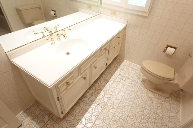 bathroom featuring tile walls, tile patterned floors, vanity, and toilet