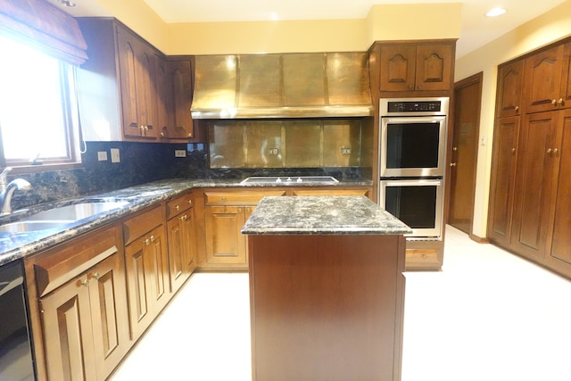 kitchen with black dishwasher, stainless steel double oven, cooktop, a kitchen island, and backsplash