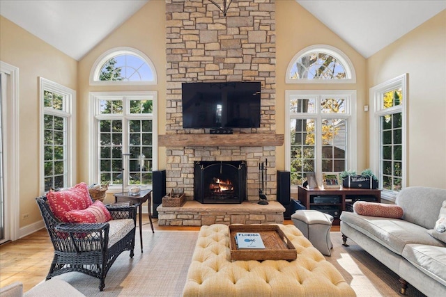 sunroom / solarium with lofted ceiling and a stone fireplace