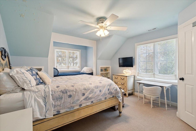 carpeted bedroom featuring multiple windows, vaulted ceiling, and ceiling fan