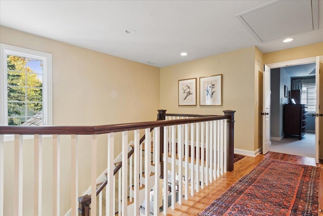 hallway with hardwood / wood-style flooring