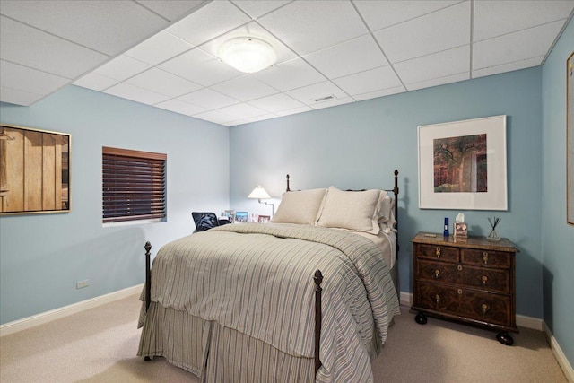 bedroom with a paneled ceiling and light carpet